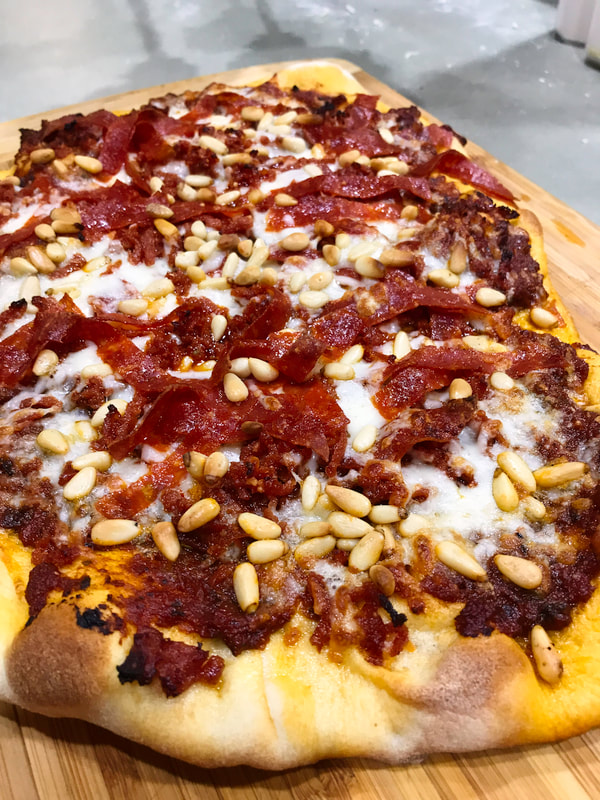 Pepperoni Pizza with sun dried tomato pesto and pine nuts on the Shibaguyz' pizza crust.